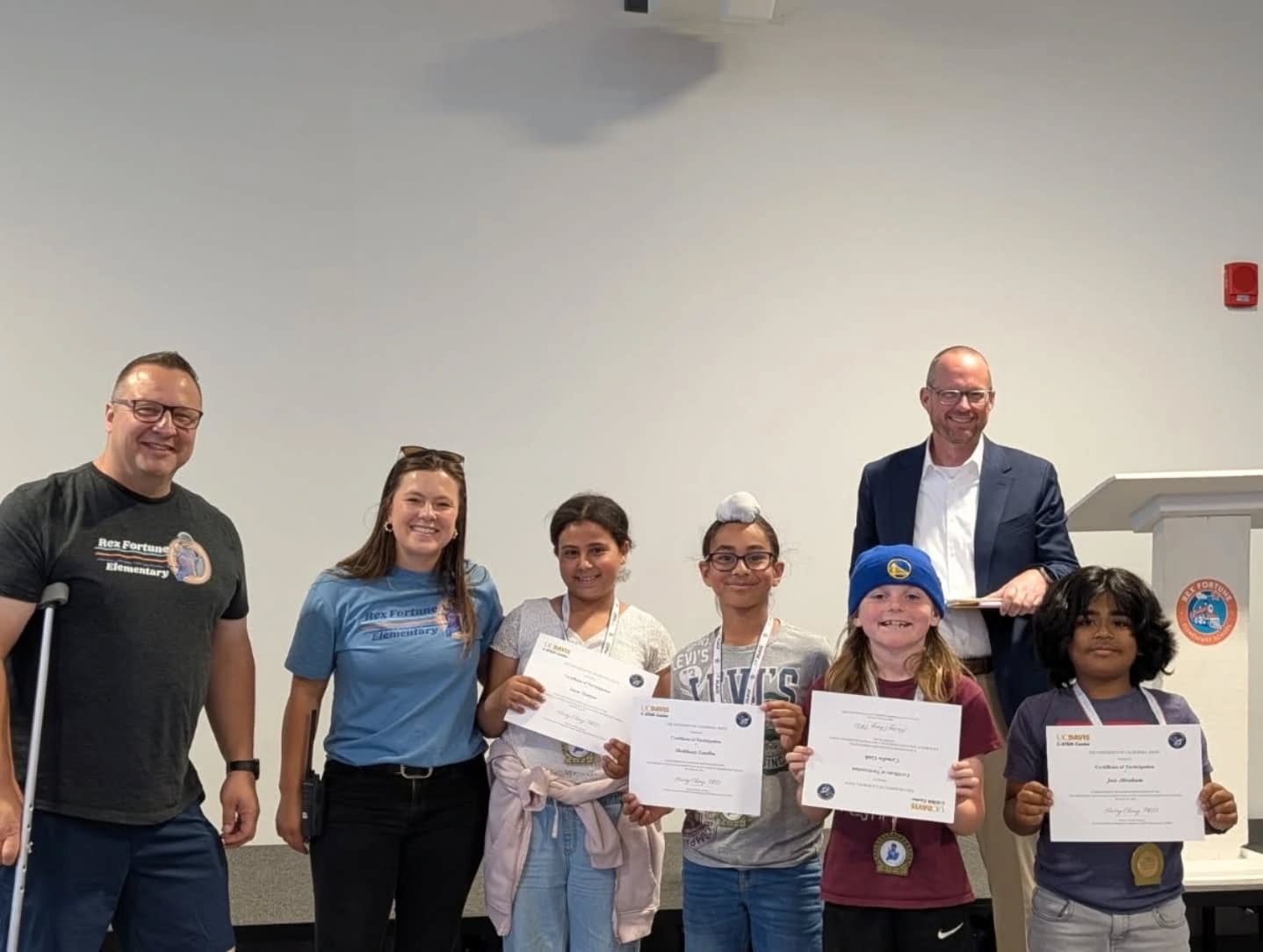 students hold up awards