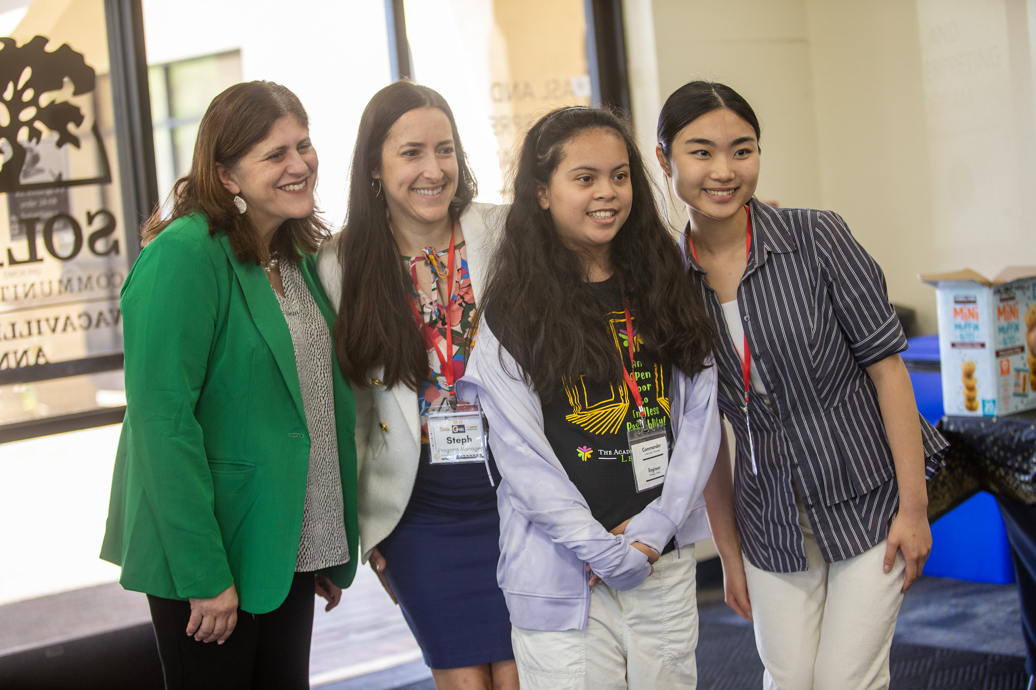 1 student and 3 mentors smiling for a photo