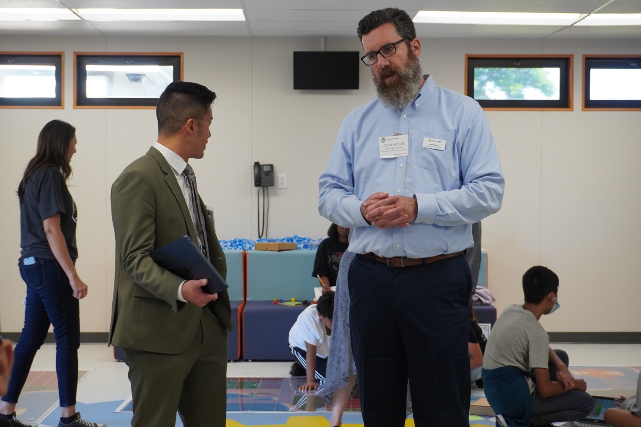 two visitors standing and watching the roboplay challenge