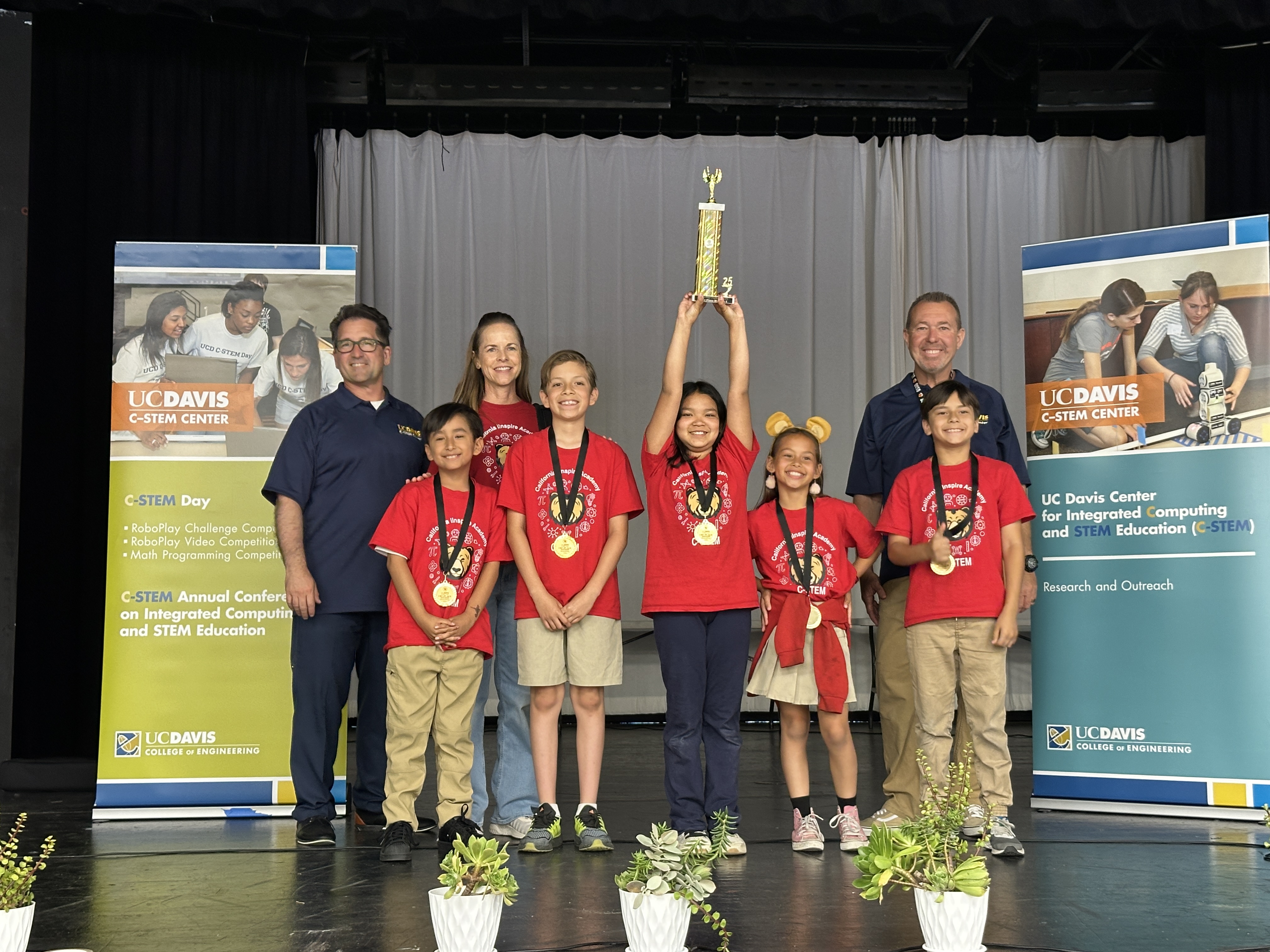 challenge winners on stage smiling