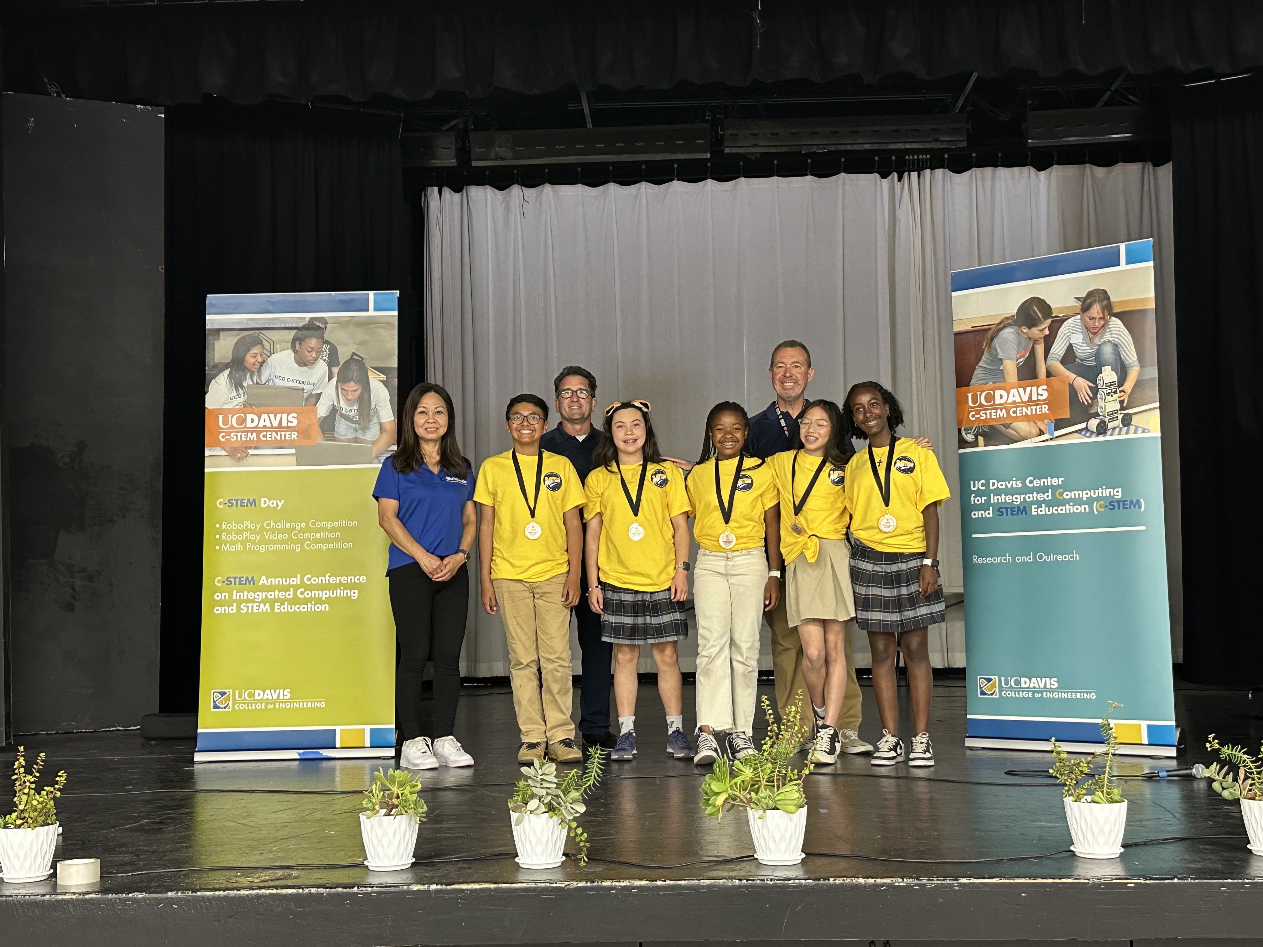 winners of the challenge smiling on stage