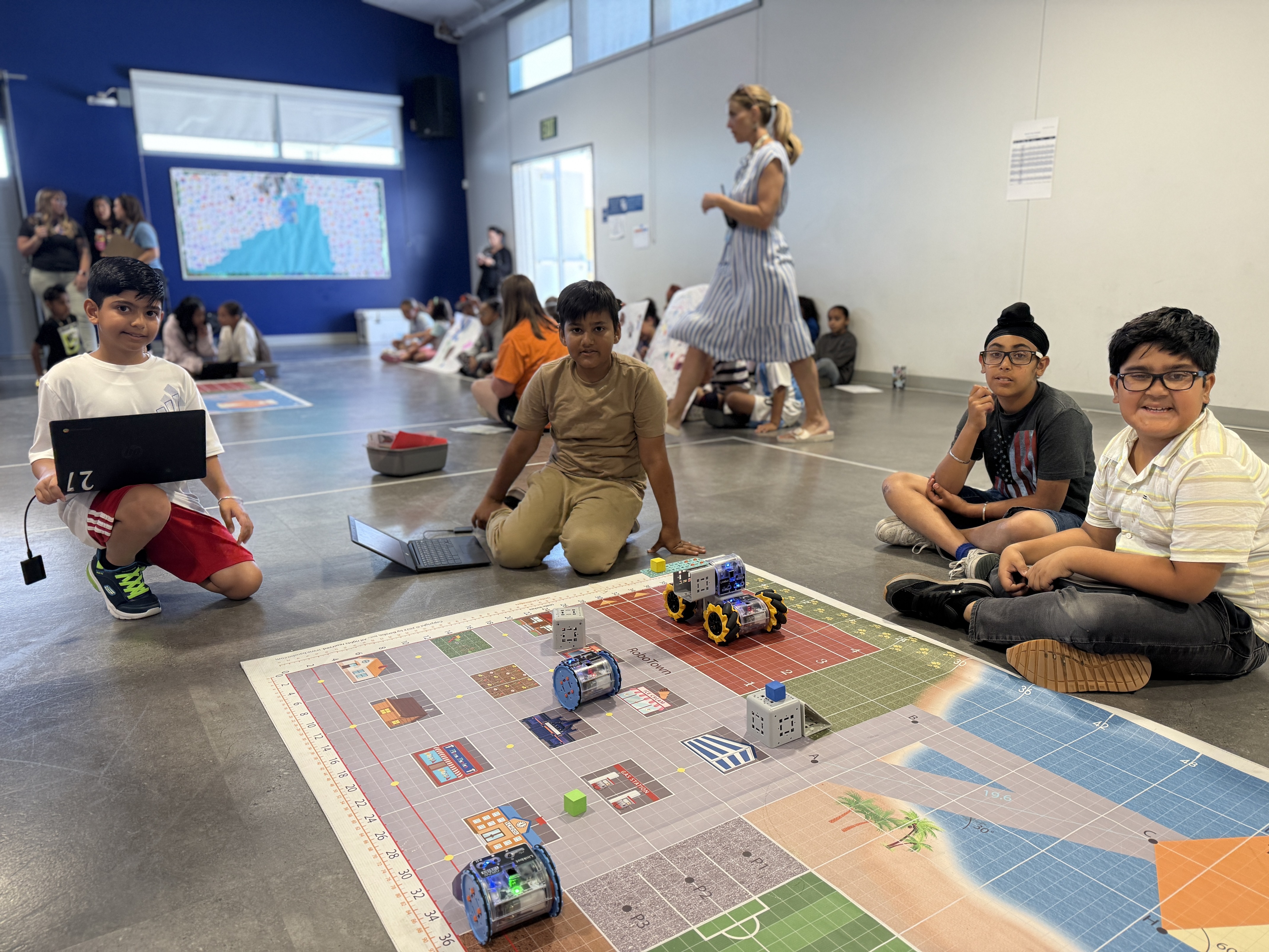 4 students sitting in front of their robots