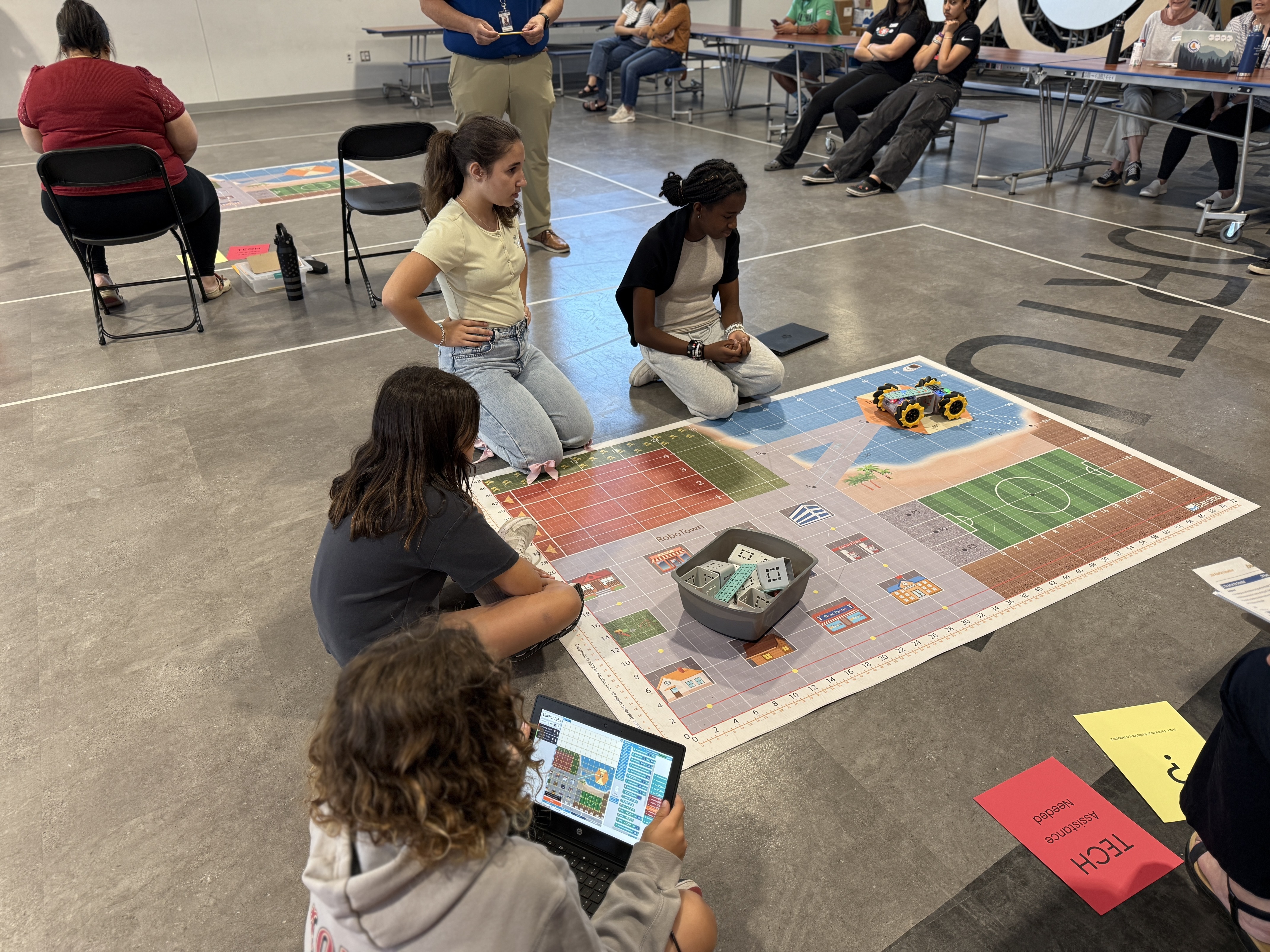 students watch a robot move across a RoboPlay mat