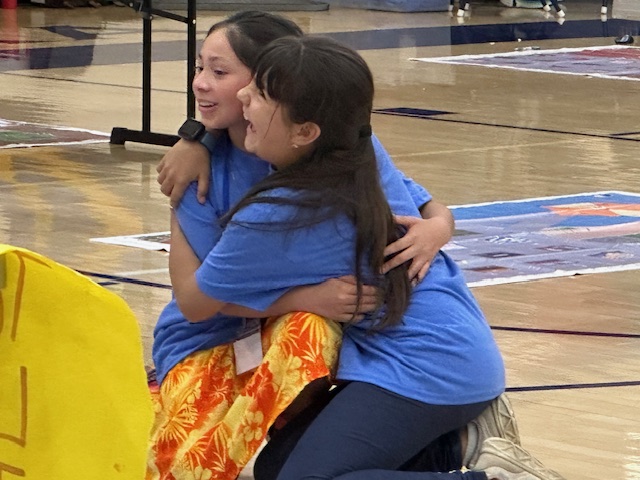 students hugging