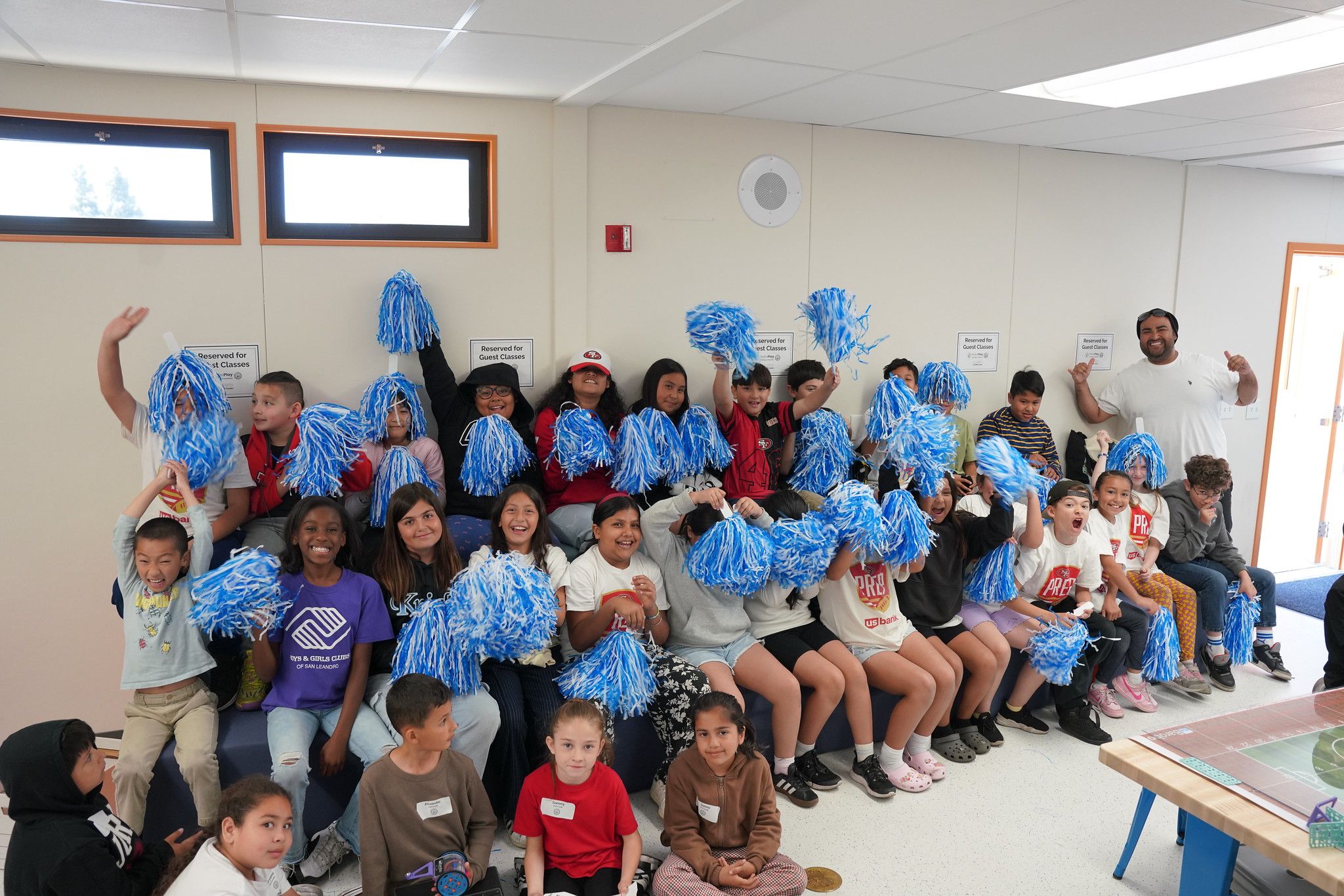 large group of students cheering with pom poms
