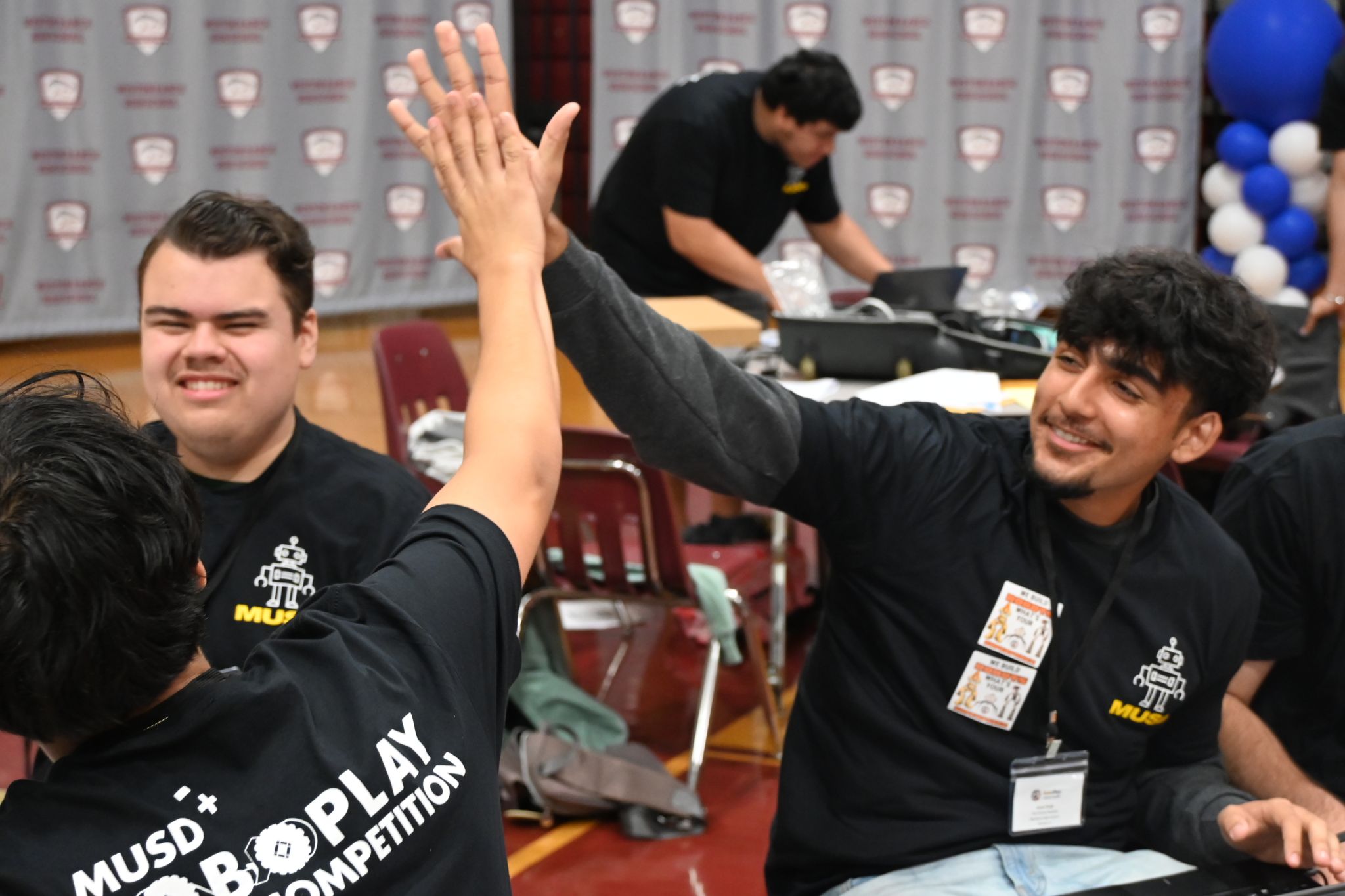 two students giving each other a high five