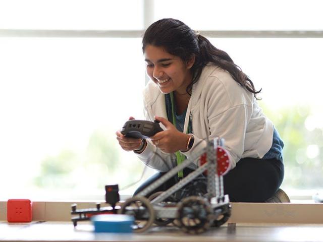 Girl controlling VEX robot