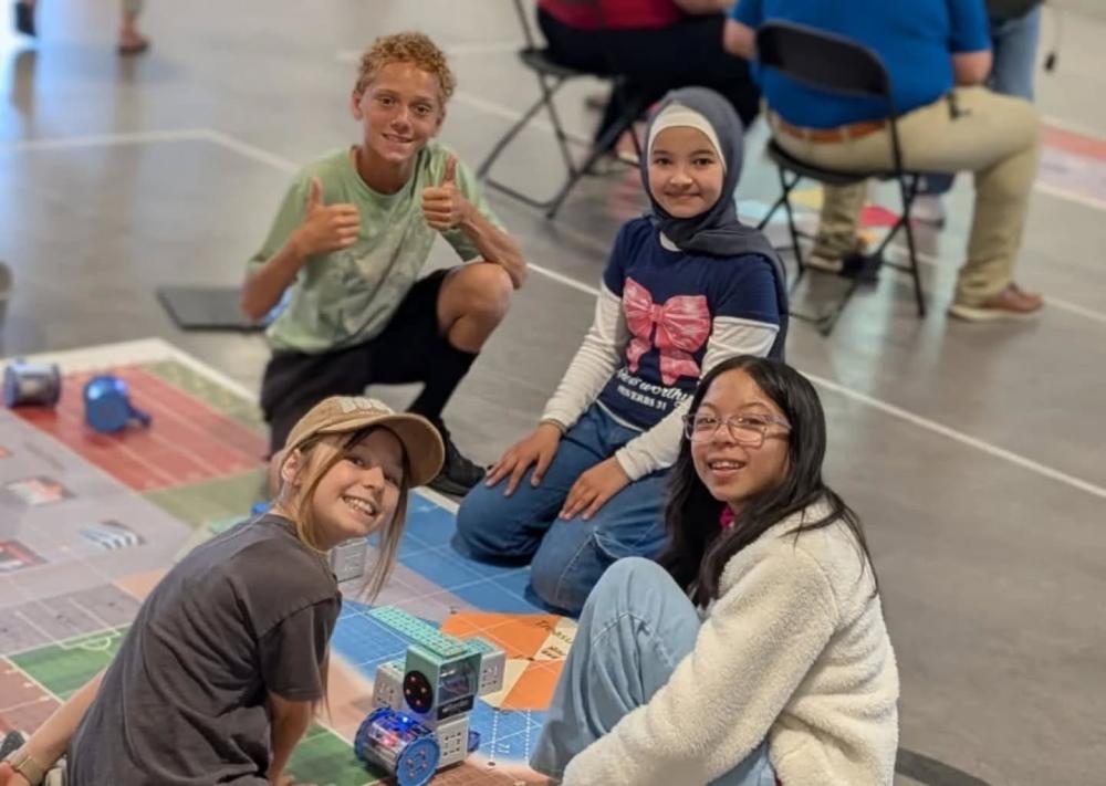 students gather around a RoboPlay mat