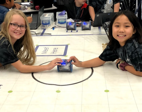 students holding linkbot